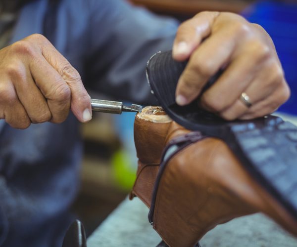 Shoemaker,Repairing,A,Shoe,Sole,In,Workshop